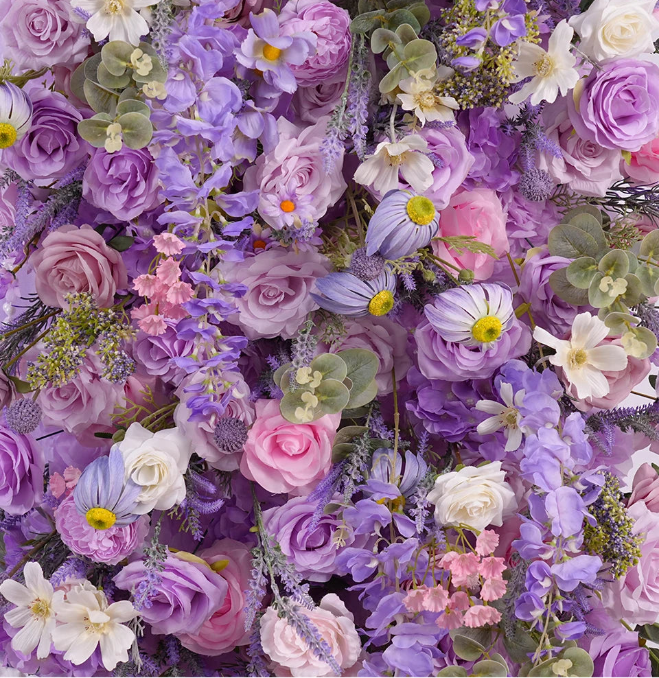 Wall of colorful flowers including purple, pink, and white varieties.