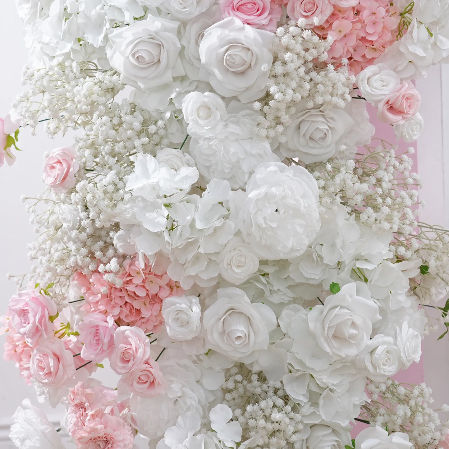 Floral arrangement with white and pink roses on a white background