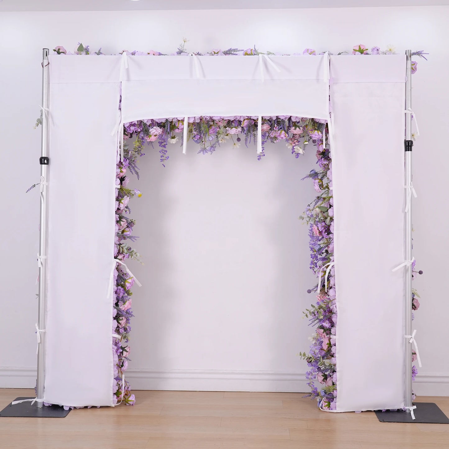 Floral arch with white curtains on a plain background