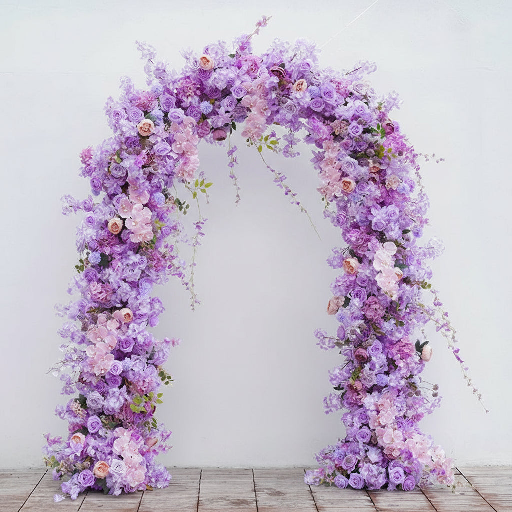 Floral arch with purple and pink flowers and a book titled 'Angela Flower' on a stand.