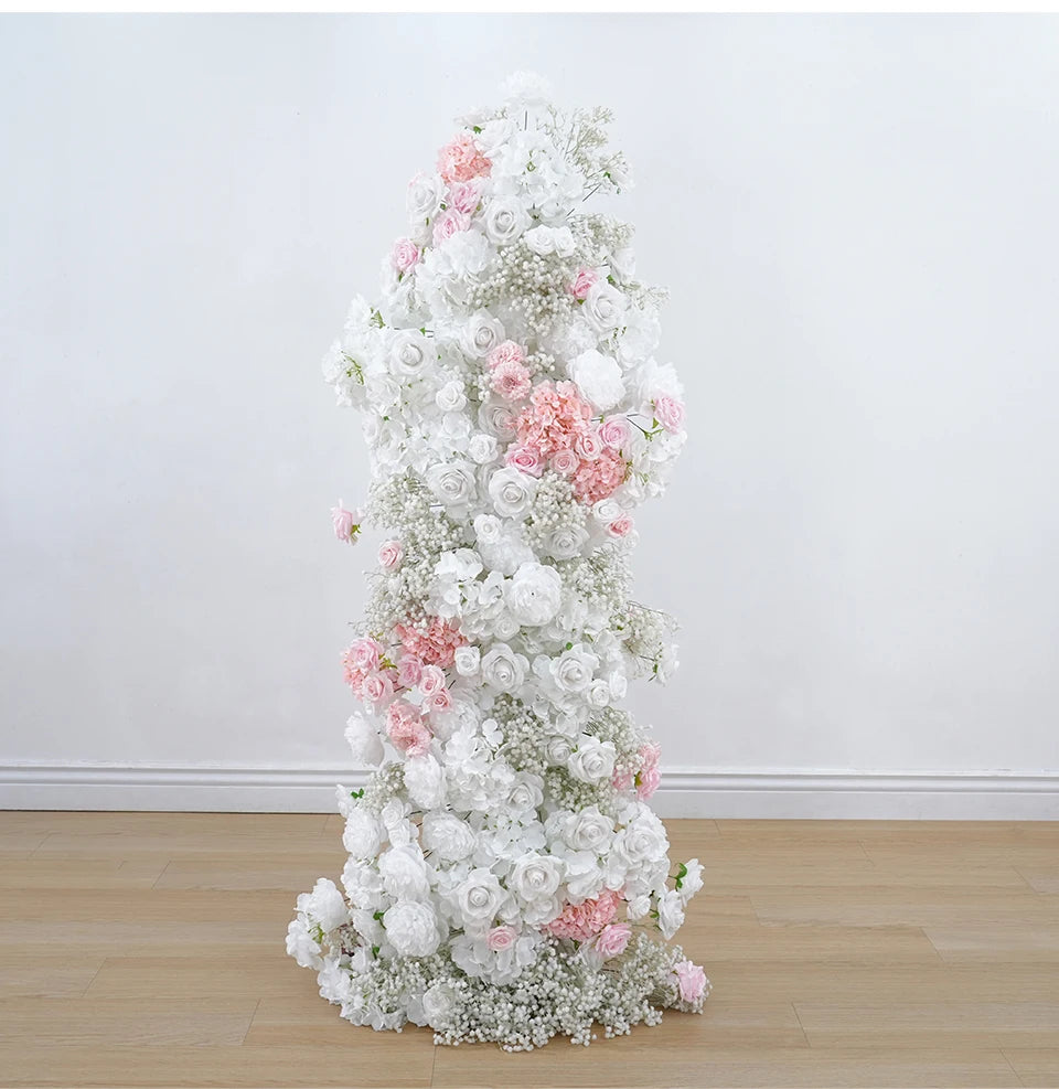 Floral arrangement with white and pink flowers on a plain background