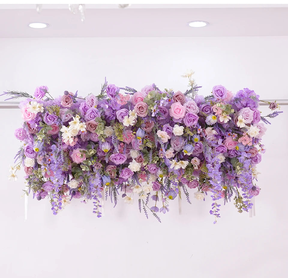 Floral arrangement with purple and pink flowers on a white background
