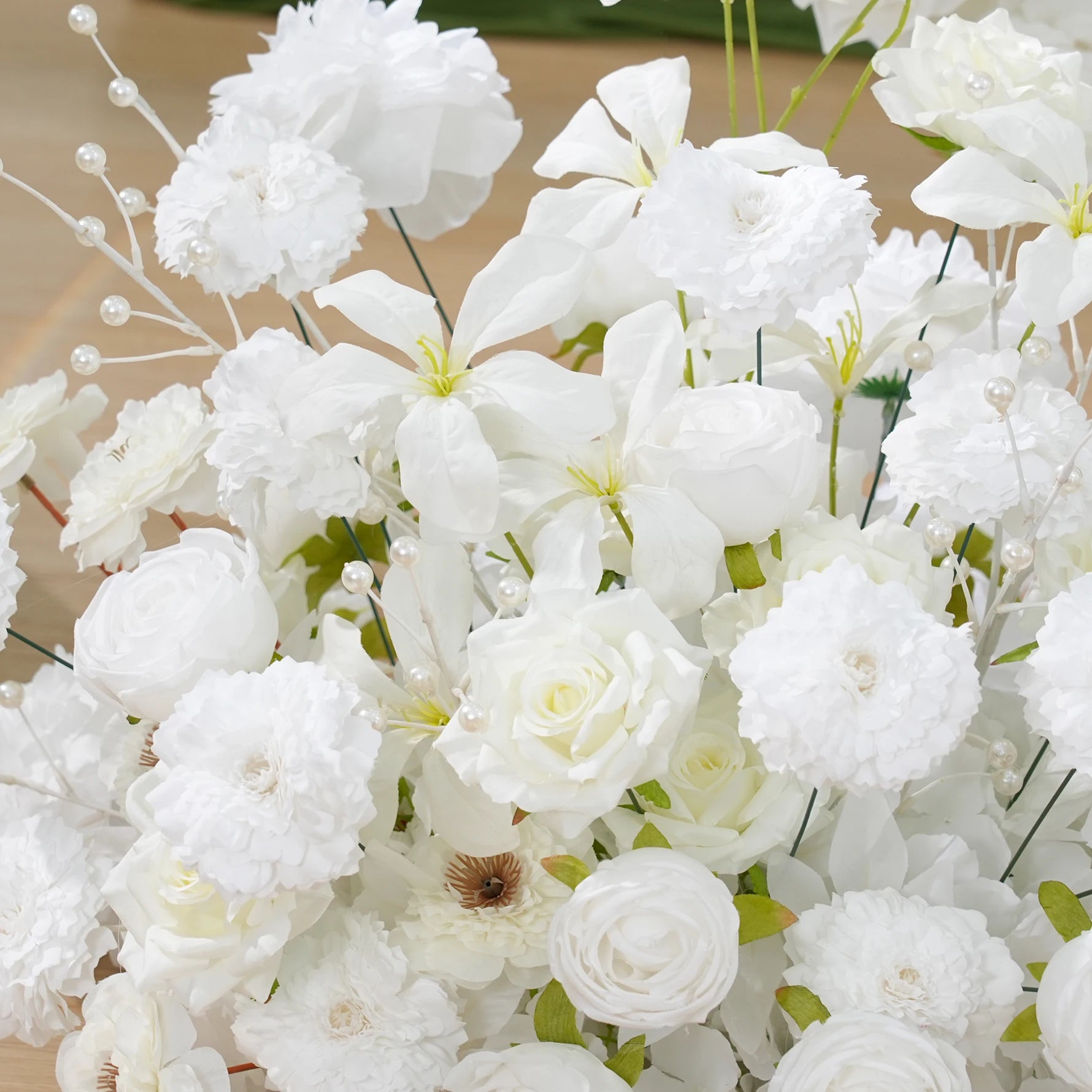 Close-up of a bouquet of white flowers with green leaves.