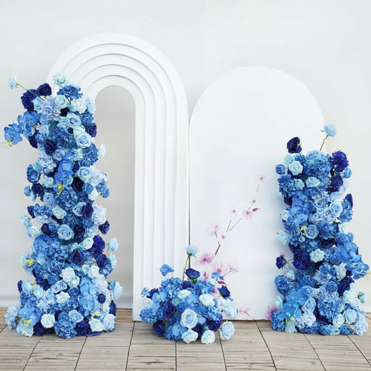 Transform your wedding venue into an elegant focal point with this luxury royal blue backdrop floral arrangement. Expertly crafted with premium blooms in rich sapphire tones, this statement piece combines sophistication with dramatic visual impact. Perfect for ceremonies, receptions, or photo opportunities, the arrangement features layered florals that create depth and dimension against any backdrop. Each stem is carefully selected and arranged to ensure lasting beauty throughout your celebration. 