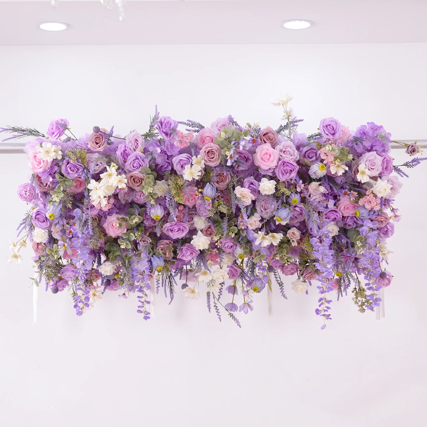 Floral arrangement with purple and pink flowers on a white background