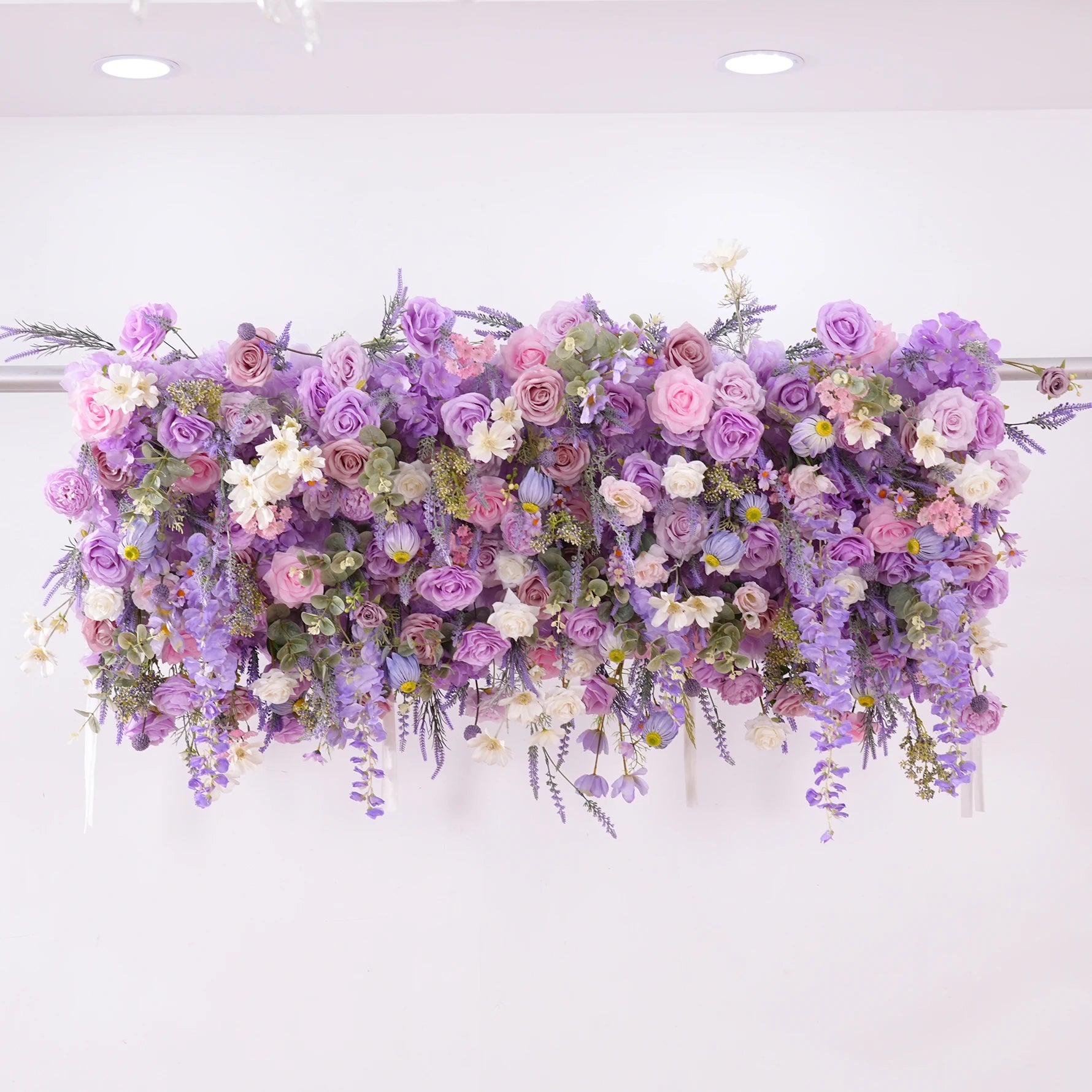 Floral arrangement with purple and pink flowers on a white background
