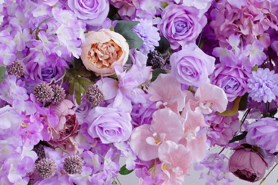 Bouquet of flowers with a mix of purple, pink, and white colors.