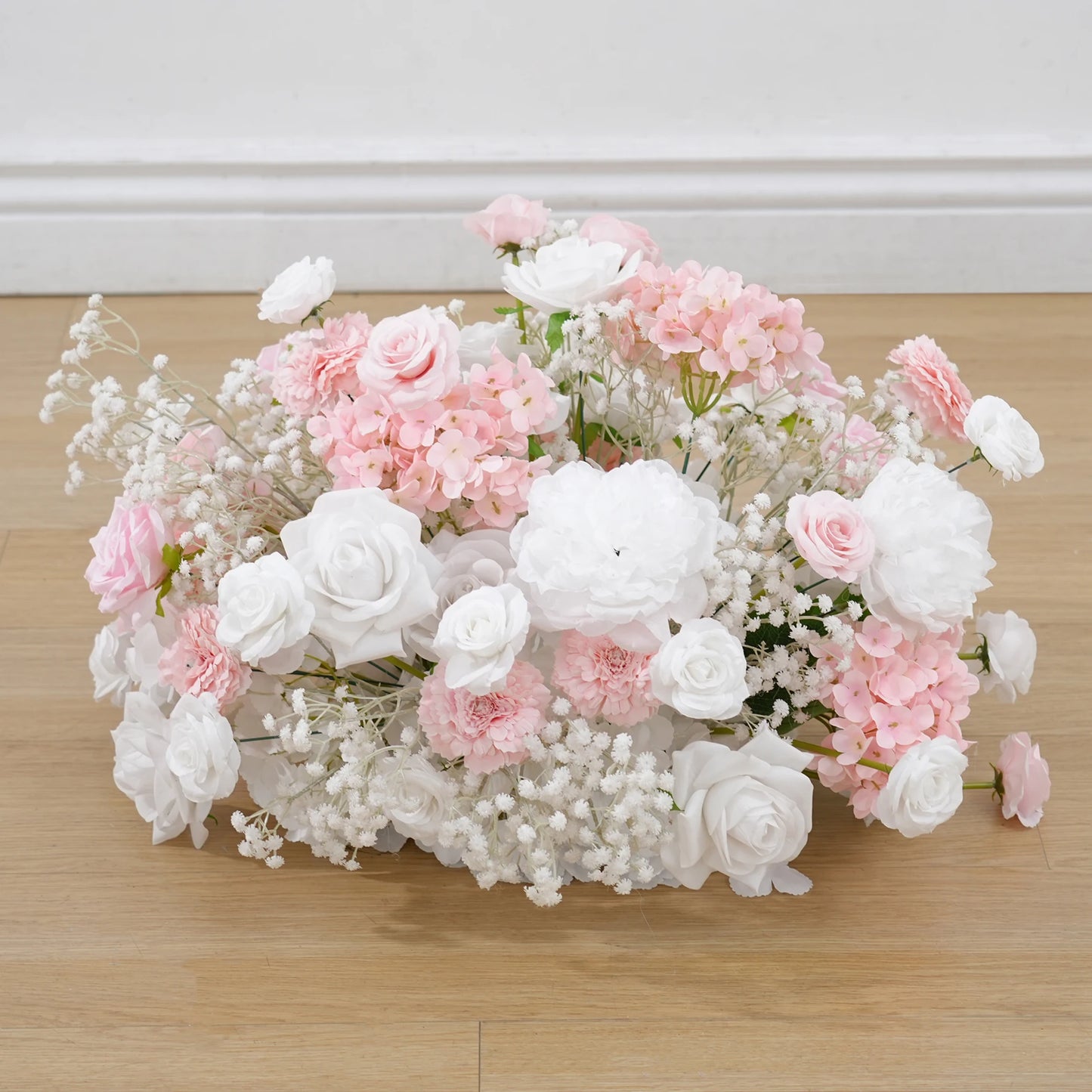 Bouquet of pink and white flowers on a wooden surface