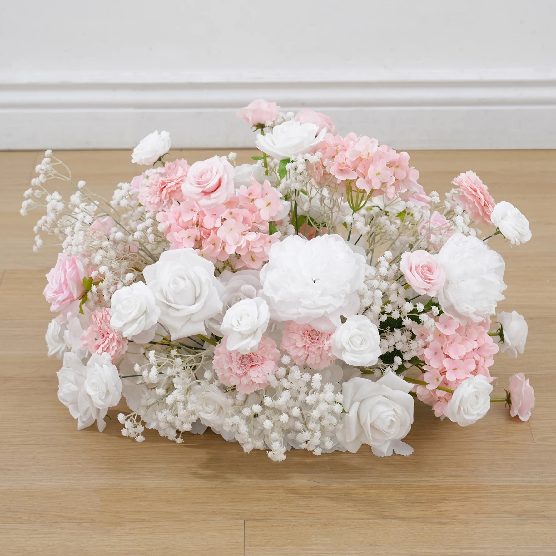 Bouquet of pink and white flowers on a wooden surface