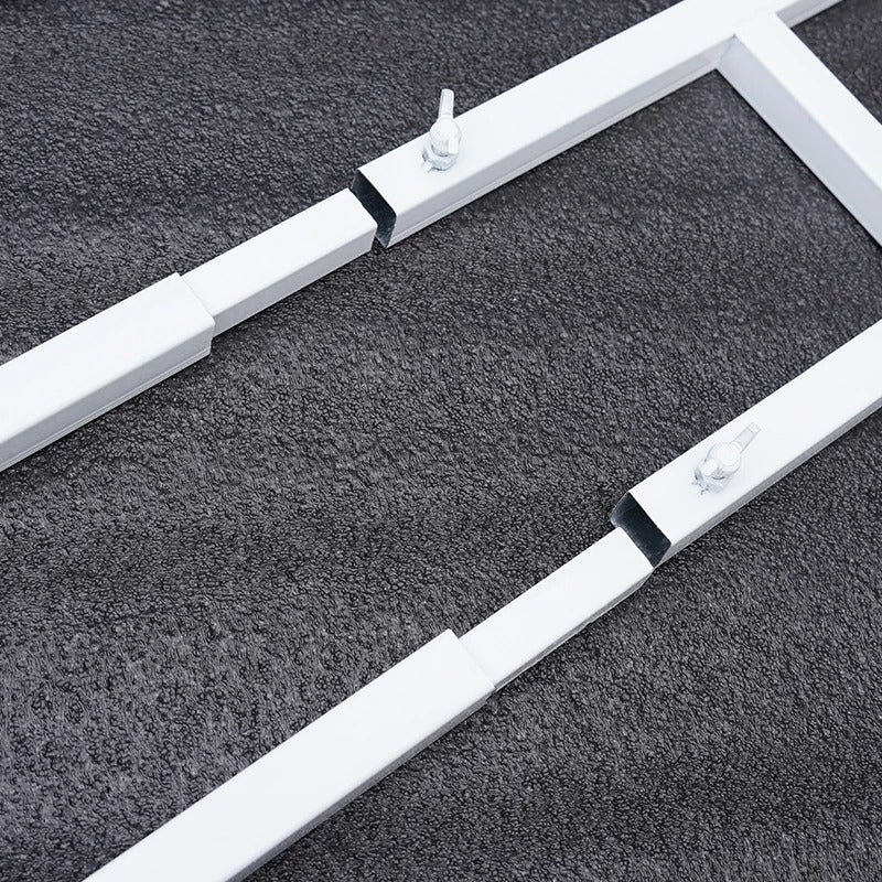 Two white metal frames with black straps on a dark textured surface