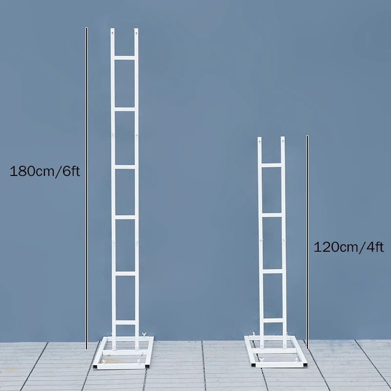 Two white ladders of different heights on a gray floor with a blue wall background.